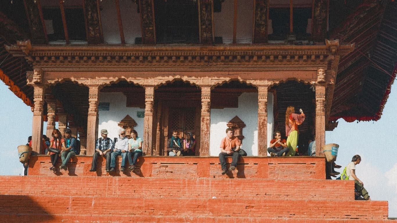 People relaxing at temple in Nepal as example of slow travel in Nepal