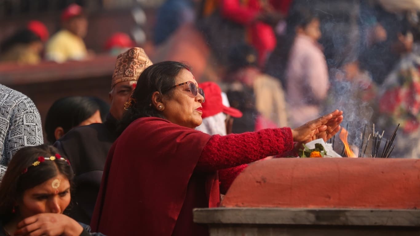 Woman is offering a a temple in Nepal, spirituality is everywhere.