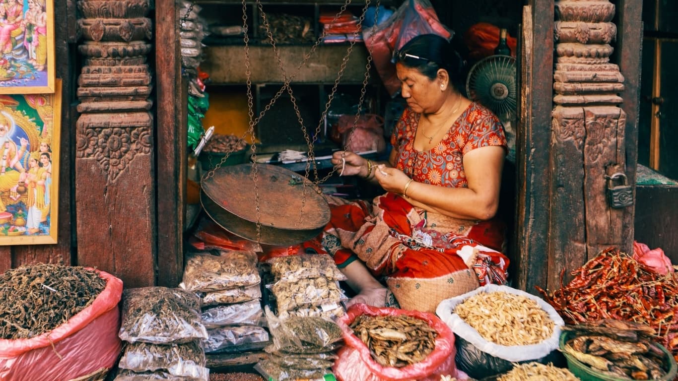 Woman in a Nepalese shop, shopkeepers communicate indirectly