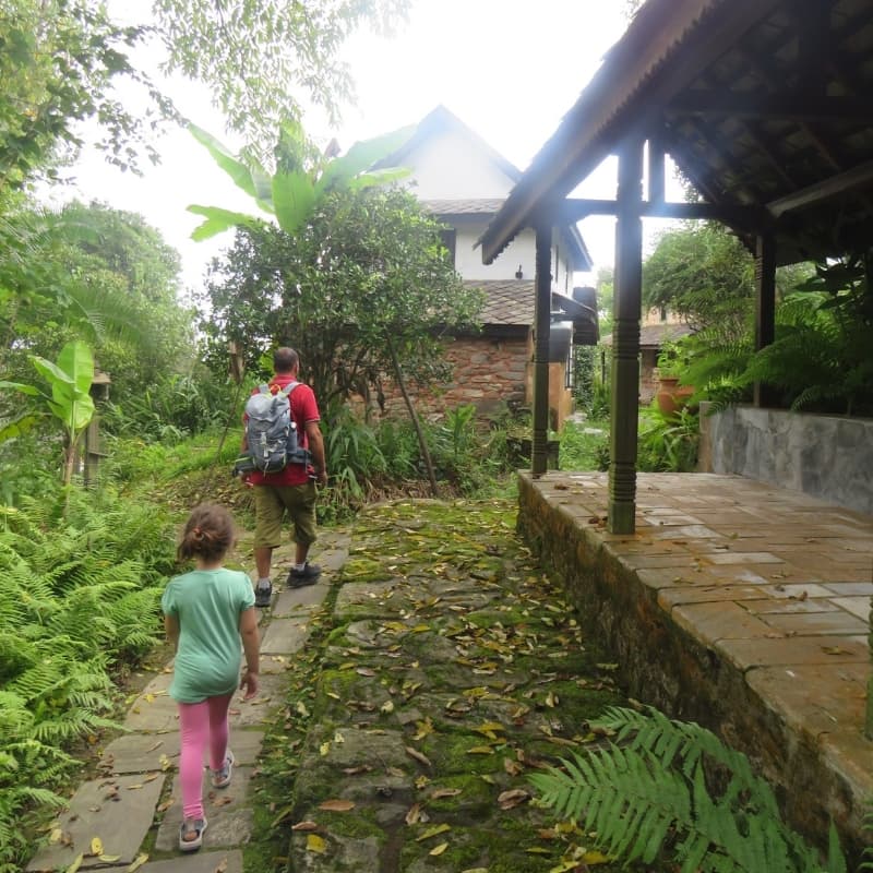 Girl walking with a Nepalese guide over the domain of Namobuddha resort