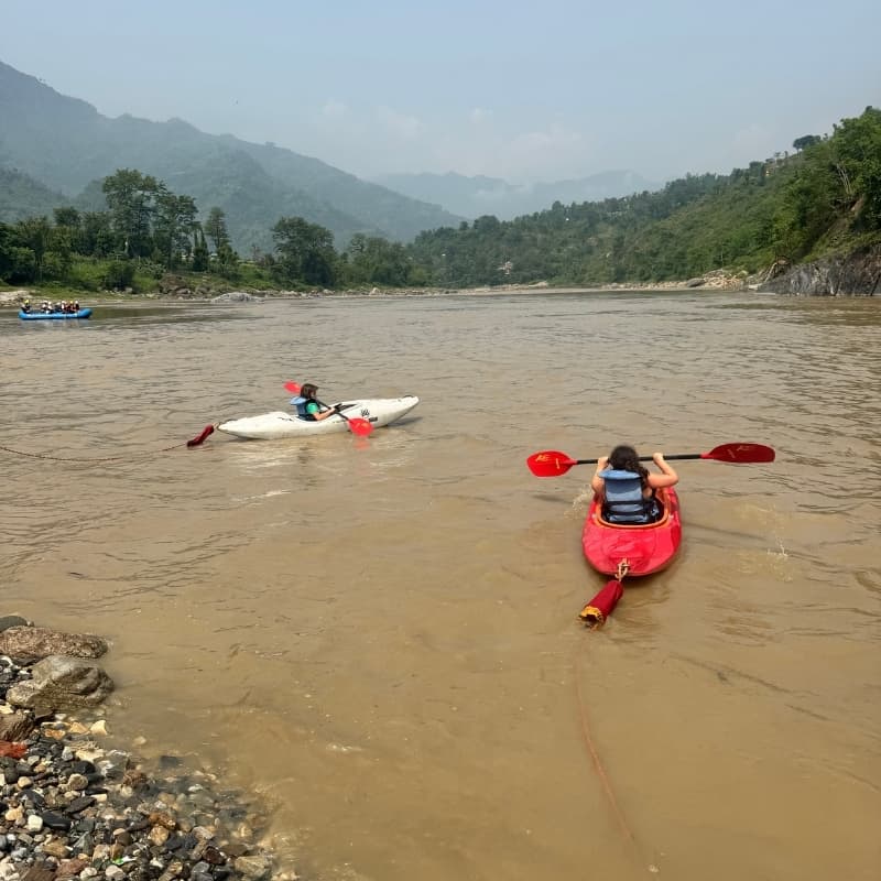 Girls trying out Kayak on the Trisuli river near Himalika camp