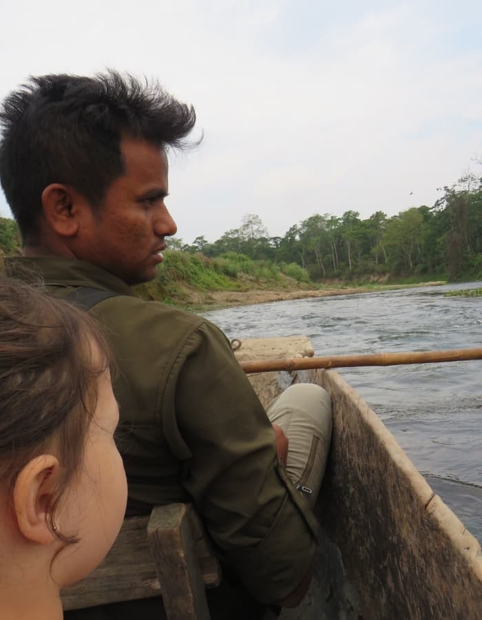Little girl in boat on the river in Chitwan with a Nepalese nature guide