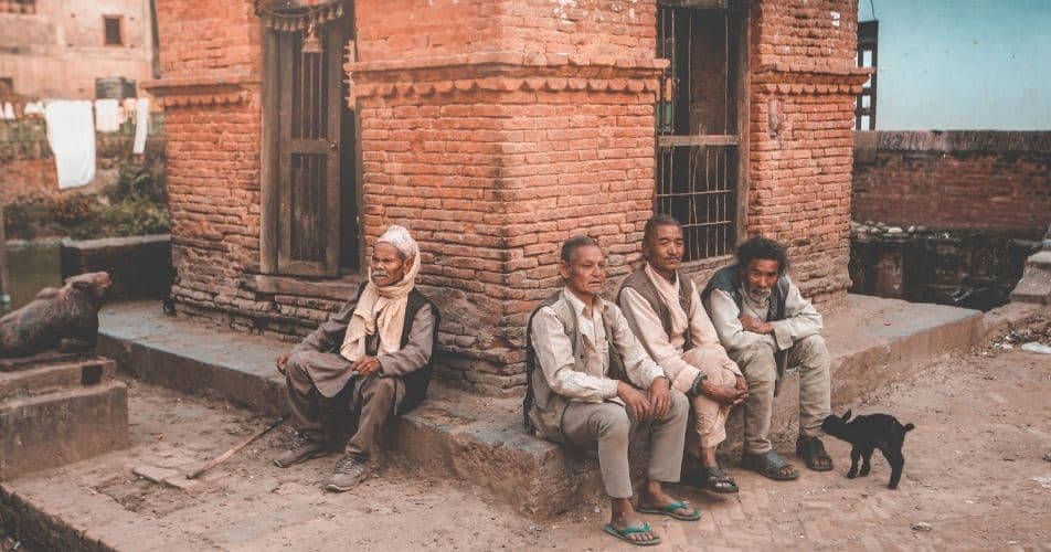 Relaxing men chatting in the streets, in Nepal time works differently