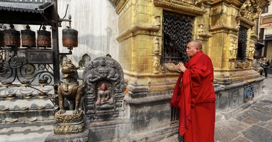 Spirituality in Nepal, a monk doing offerings at a buddhist temple