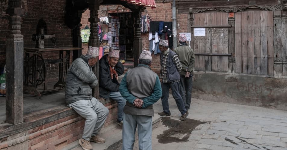 Nepalese men chatting in the street, indirect communication