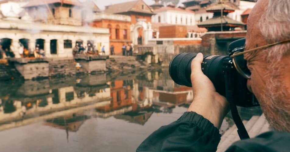 Older traveller taking pictures in Pashupatinath and taking his time