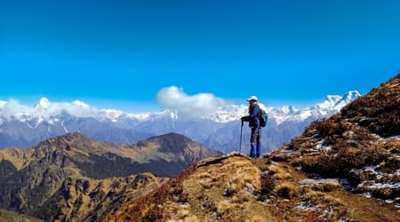 Trekker in the Himalayas in Nepal with blue skies during the best time to trek in Nepal